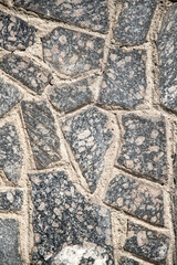 Asphalt paving stone old background with cracks.