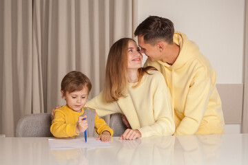 Lovely cute family, parents with son painting