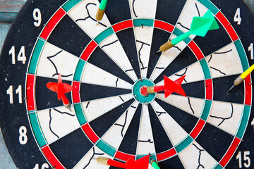 Business concept. darts arrows in the target center with paper note for Writing goals for this business year