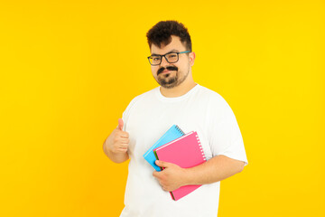 Concept of people, young fat man on yellow background
