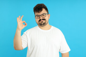 Concept of people, young fat man on blue background