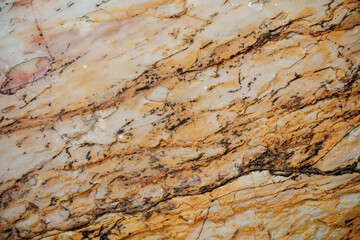 Background. The texture of a flat natural yellow-beige wet stone with stripes.