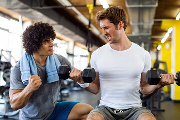 Fit man working out in gym with personal trainer to stay healthy. Sport, people concept