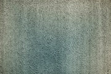 A wall painted in green and grey color.