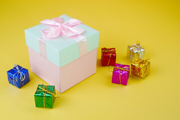 Pink and cyan present with bow and small colorful presents.