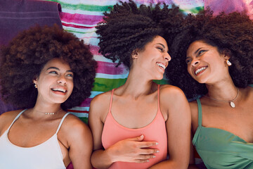 African women, happy and friends on floor for support, love and care or bonding together at beach. Black girls, smile and friendship happiness, laughing with afro and fun on summer holiday