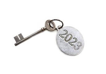 2023 engraved on a ring of an old key isolated on white background