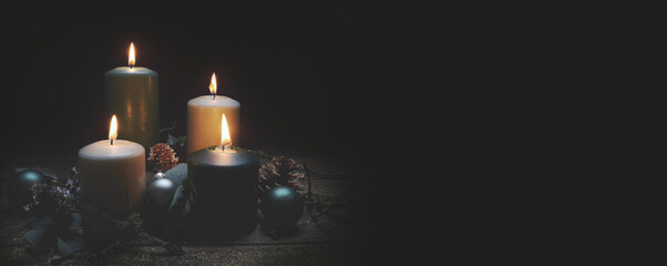 Christmas background - Four burning advent candles in dark night