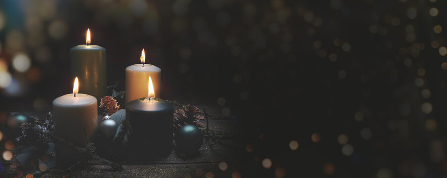 Christmas background - Four burning advent candles in dark night - Fourth Advent