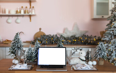 Computer laptop with blank screen in christmas tree winter backgrounds