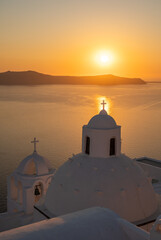 Fototapeta premium Santorini, white church against colorful sunset in Greece