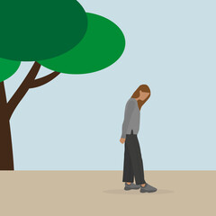 Young woman standing and looking down in the park