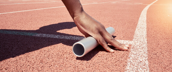 Stadium start track, athlete hands and relay ready for runner competition, sports race and fitness exercise. Marathon training, asphalt wellness workout and woman hand with baton for running match