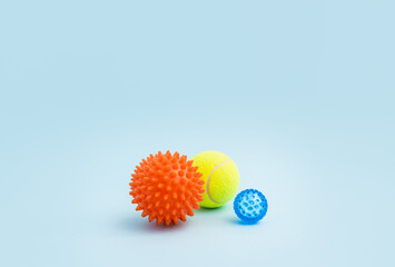 Set of three myofascial release balls for trigger points. Equipment for MFR, alternative medicine and physiotherapy. Tools for self massage on blue background. Reflexology therapy concept.