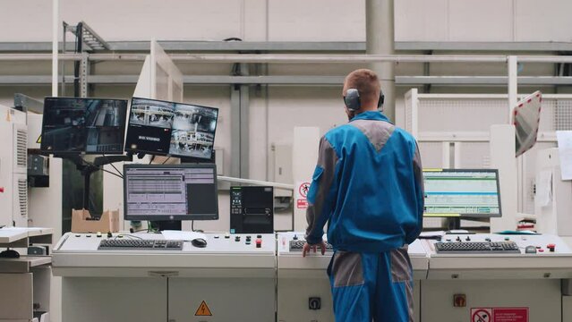Modern factory: a male operator manages the production line of an enterprise.