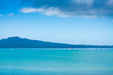 Small sailing boats scattered over calm waters of Auckland Harbour on a glorious winter day....