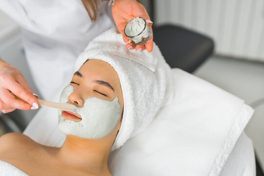 it is necessary to take care of ourselves - Asian woman having a face mask procedure at the spa center. High quality photo