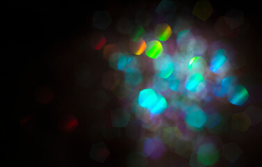 multicolored bright bokeh on black background with copy space