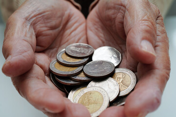 Retired elderly woman holding Euro banknotes money and worry about monthly expenses and treatment...