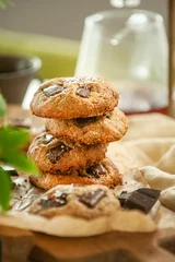 Foto op Canvas Vertical closeup of freshly baked cookies on the table blurred background © Simone Oppes/Wirestock Creators