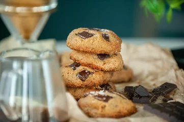Fotobehang Closeup of freshly baked cookies on the table blurred background © Simone Oppes/Wirestock Creators