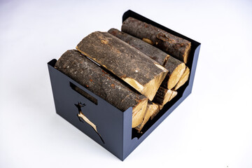 A metal box for firewood with wood logs in it on white background in a studio photoshoot. High quality photo