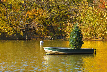 Boat with Funny Christmas tree in Lake near Loeb Boathouse in Central Park. New York City