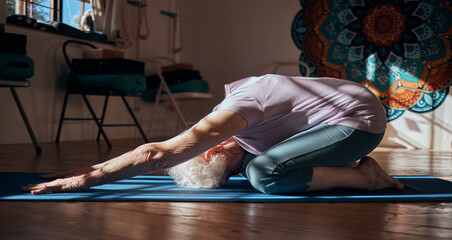 Senior woman, stretching and yoga exercise in living room for fitness, cardio and wellness on mat...