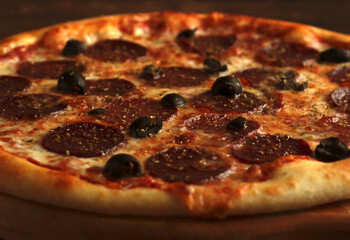 pepperoni pizza with salts and olives close-up