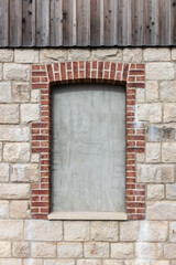 Bricked up window of an old building wall