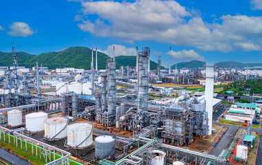 The oil refinery plant form industry zone ,which the factory - petrochemical plant, Shot from drone of Oil refinery as blue sky scenery background