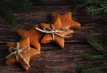 ginger cookies in the form of stars with cinnamon and spruce branches