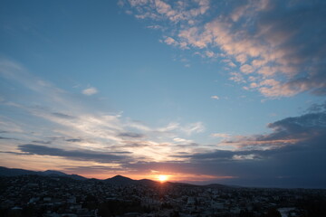 sunrise over Kutaisi. The first rays of the rising sun illuminate dramatic clouds over Kutaisi, Georgia