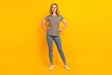 Fototapeta na wymiar Full length portrait of beautiful young woman smiling hands on waist isolated bright color background