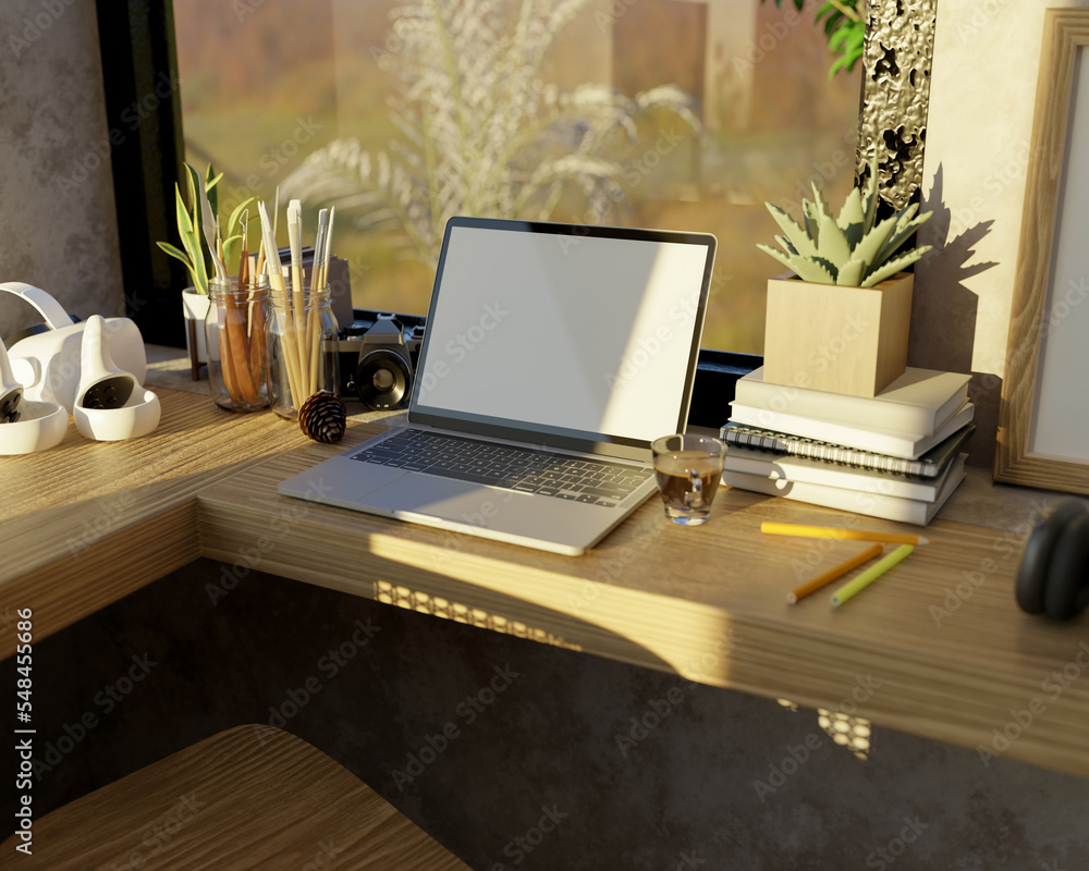 Poster comfortable and minimal workspace with laptop and stuff on wood table against the window