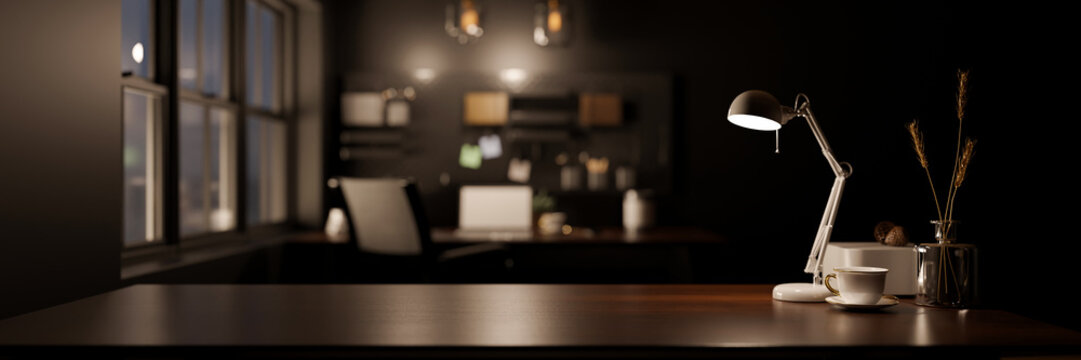 Stylish dark workspace tabletop with copy space over blurred modern dark office background