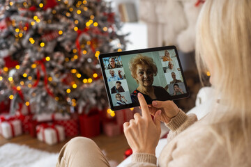 woman with tablet on the background of a Christmas tree