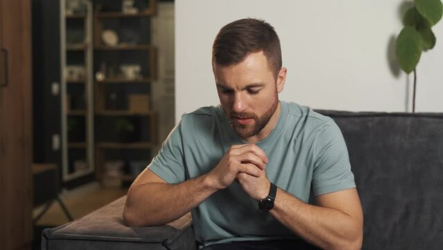 Worried excited man alone with himself trying to focus and take control of himself
