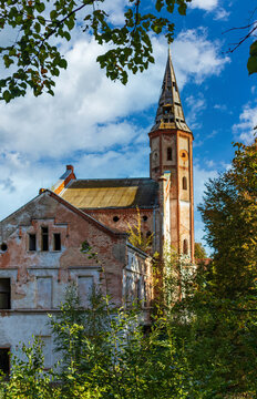 An old abandoned brick building with a tower. The main building of the former Allenberg psychiatric complex in Znamensk, Kaliningrad region.