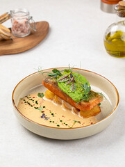 Portion of gourmet dish with trout and avocado