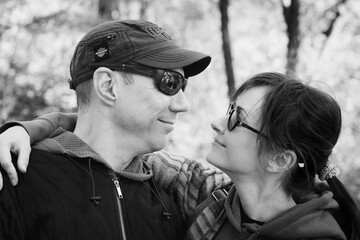 Couple hugs, black and white. Romantic gesture. Love concept. Lovers watching each other. Tender touch. Happy relationship. Love for two. Man and woman together. Couple portrait.