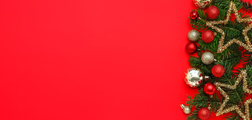 Composition with fir branches and beautiful Christmas decorations on red background with space for text