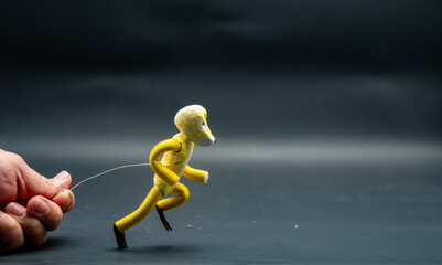 Process of running stopmotion. Start of running. Man's hand holding with aluminum wire a figure...
