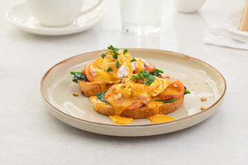 Portion of eggs benedict toast with salmon and herbs breakfast