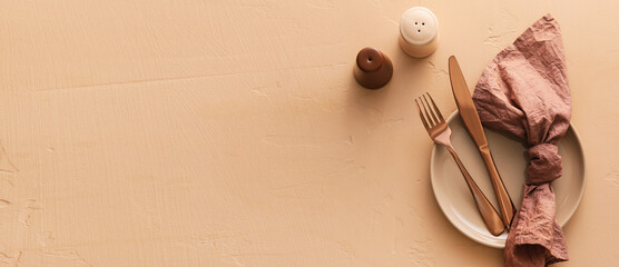 Simple table setting on beige background with space for text