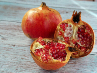 Pomegranate fruit. Whole and broken pink pomegranates
