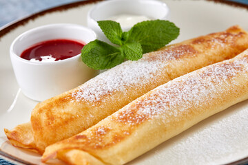 stuffed pancakes with jam and sour cream