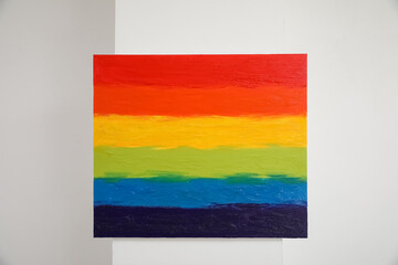 Painting of LGBT flag on light wall