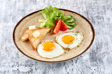 fried eggs with vegetables and toast
