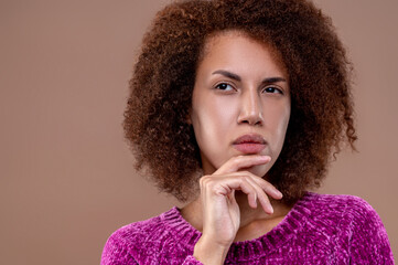 Dark-haired young woman looking thoughtful